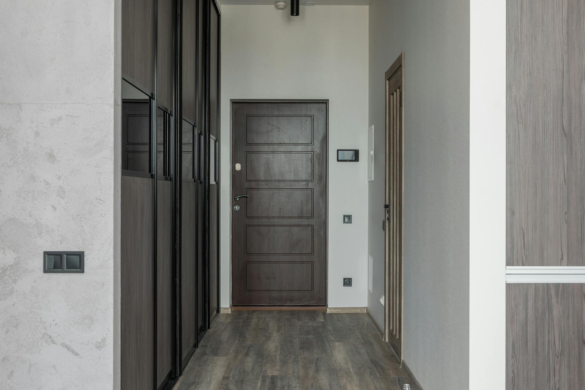 Installed hallway panelling in Turin apartment showing custom timber trim detail